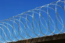 Concertina wire on a concrete fence